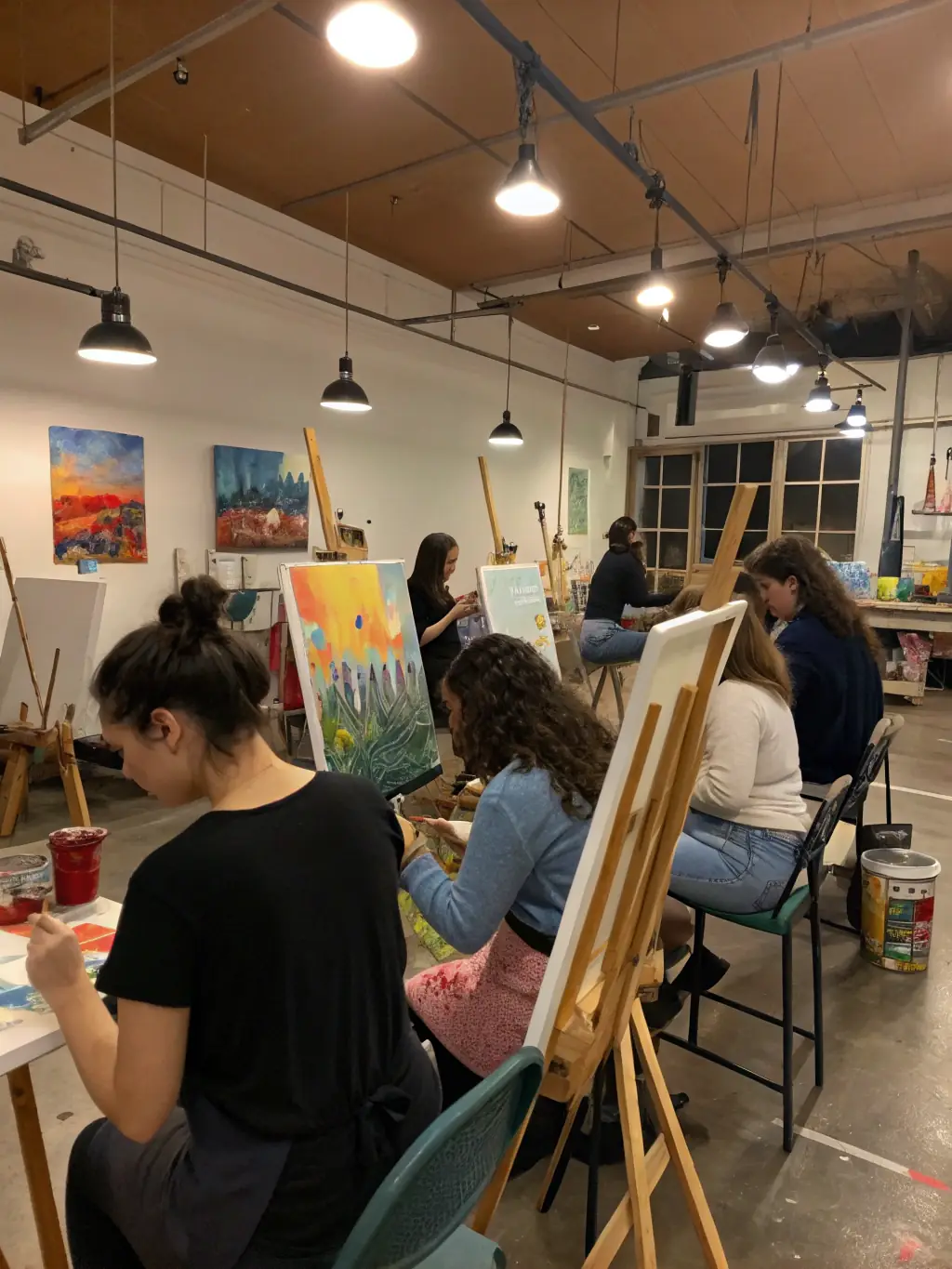 A photograph of a group of young people participating in a youth arts program, learning new skills and expressing themselves through various art forms.